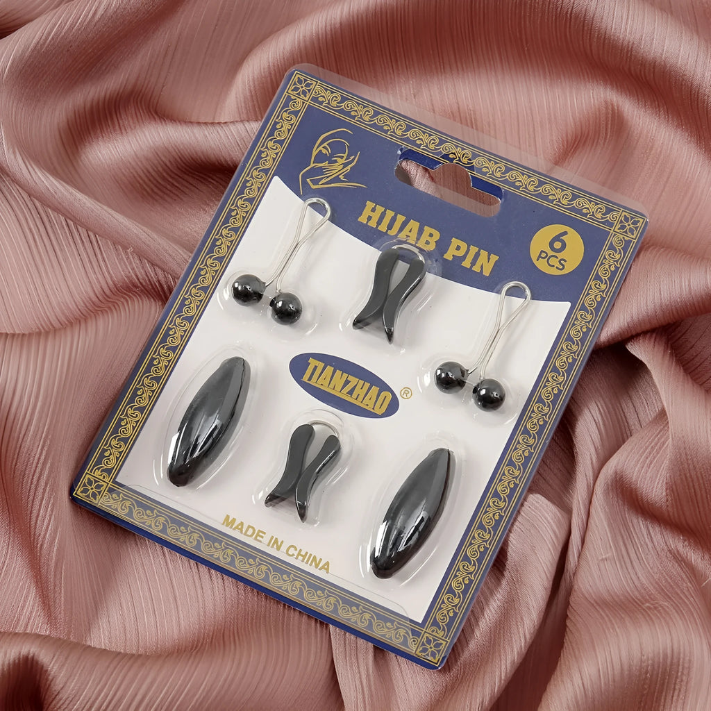 Plastic scarf clip with oval meander pattern and resin drip finish in five colours including black, gray, white, brown, and pink.