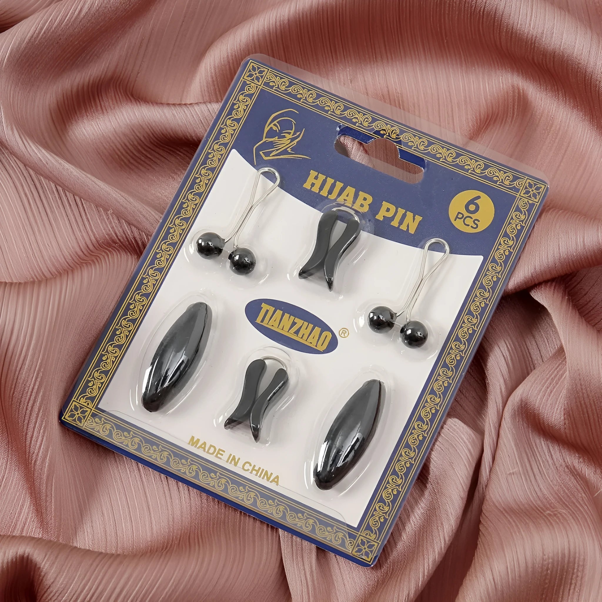 Plastic scarf clip with oval meander pattern and resin drip finish in five colours including black, gray, white, brown, and pink.