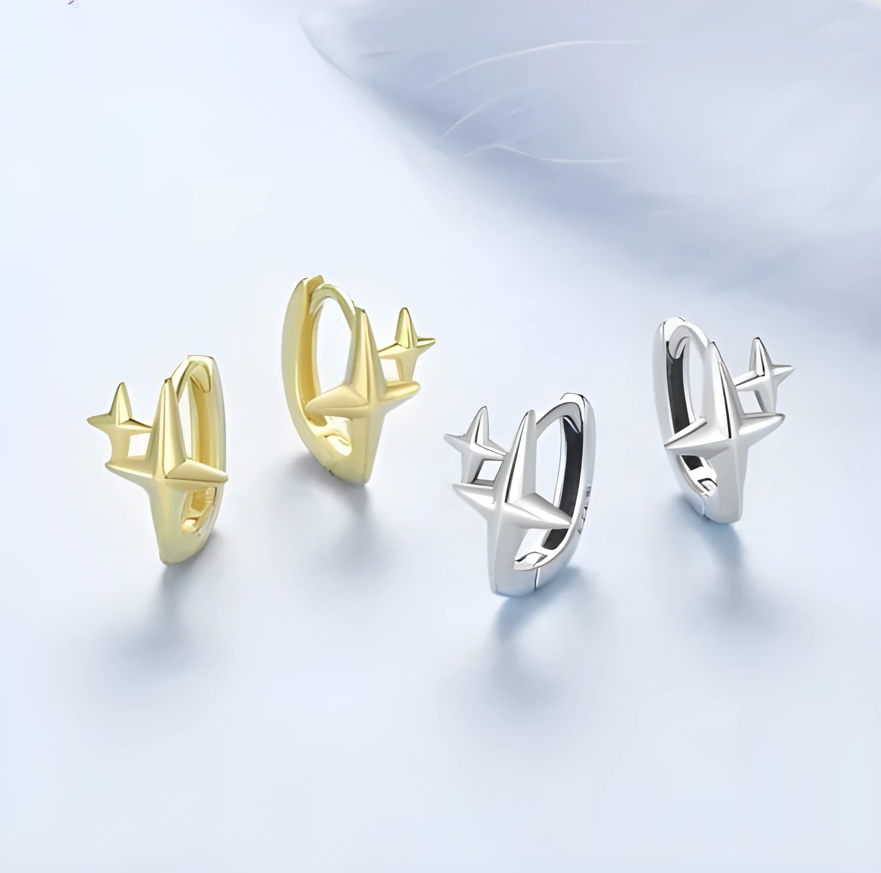 Minimalist star design sterling silver clip-on earring with XINGX motif.