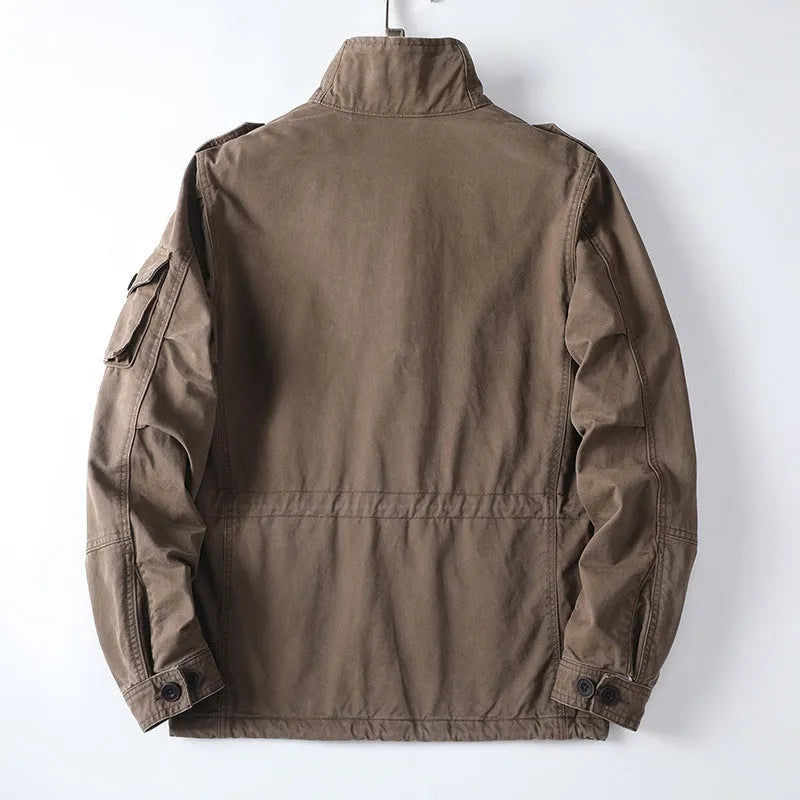 Man wearing a light brown loose-fit cotton zip-up jacket, retro casual style.