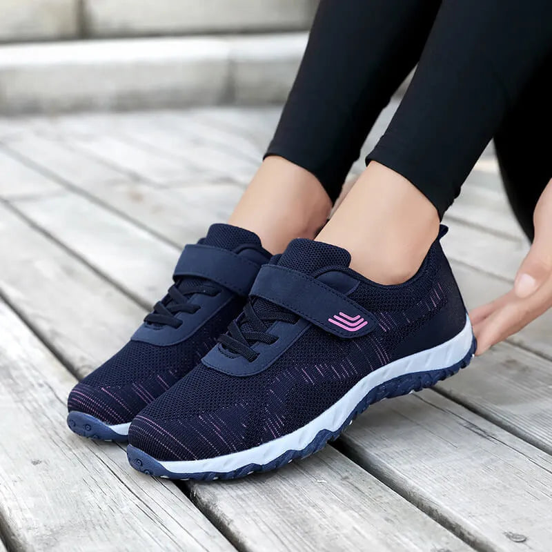 Women's gray purple low-top casual shoes with velcro strap and wedge heel.