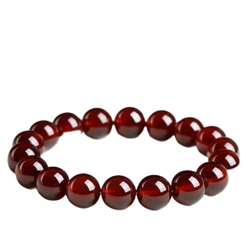 Natural orange red garnet ball bracelet in retro unisex style on wrist, showing crystal links and ruyi design details.