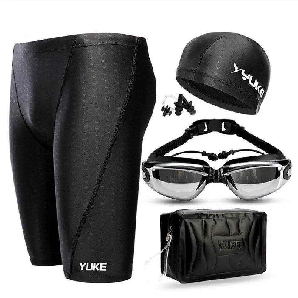 Men's black five-piece swimming set including trunks, goggles, cap, ear plugs, nose clip, and carry bag laid out flat.