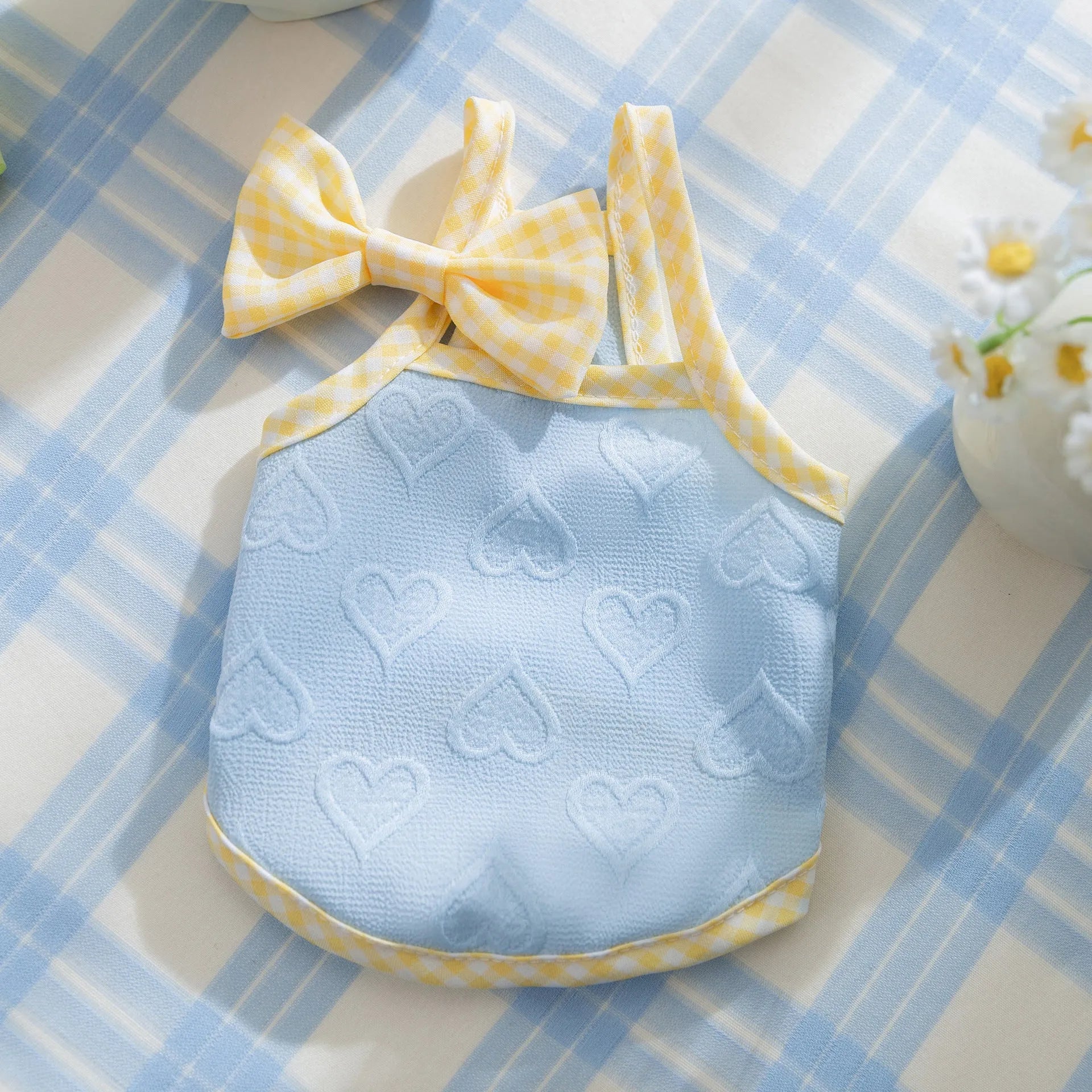 Small dog wearing heart relief texture bow suspenders vest in Bondi Blue colour with matching hairband