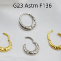 Close-up of a titanium concave-convex nose ring in gold finish, showing its textured profile and 1.2mm thickness.