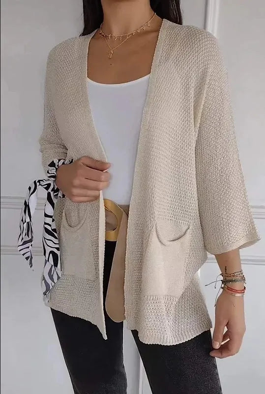 Women's army green waffle weave cardigan coat with nine-quarter length sleeves and pockets.
