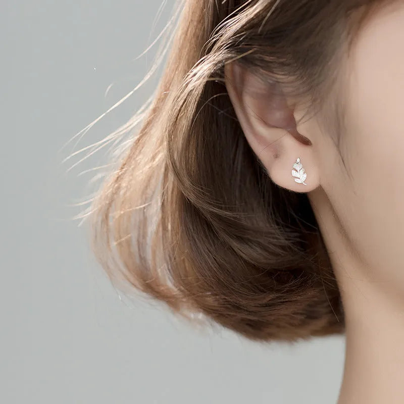 Copper willow leaf stud earrings with micro-inlaid leaf detailing, rose gold or white gold finish, side view on white background
