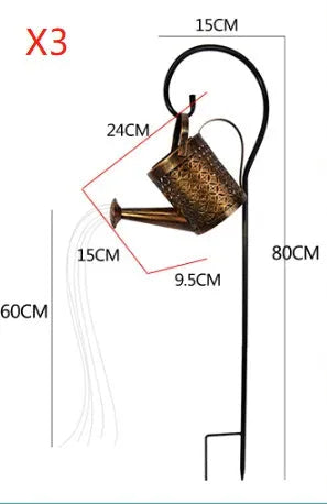 Enchanted watering can solar lamp with warm white star-shaped LED lights in a garden setting