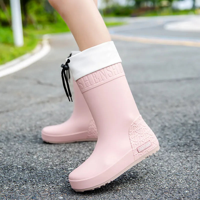 Women's solid colour PVC rain boots with non-slip soles in apricot, black, brown, and pink waterproof mouth options