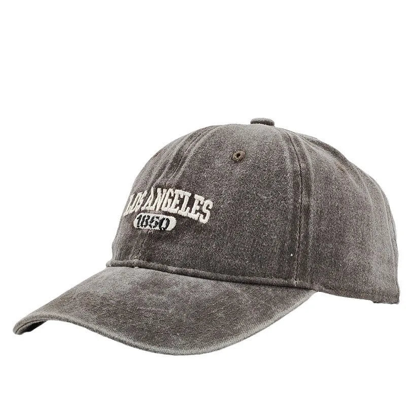 Retro-style personalised baseball cap with distressed letter embroidery on an adjustable strap, shown in beige colour.
