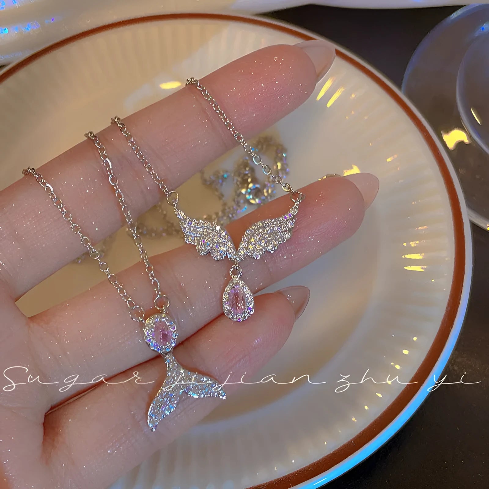 Women's sterling silver necklace with a choice of fishtail or angel wing pendant on an O-ring chain.