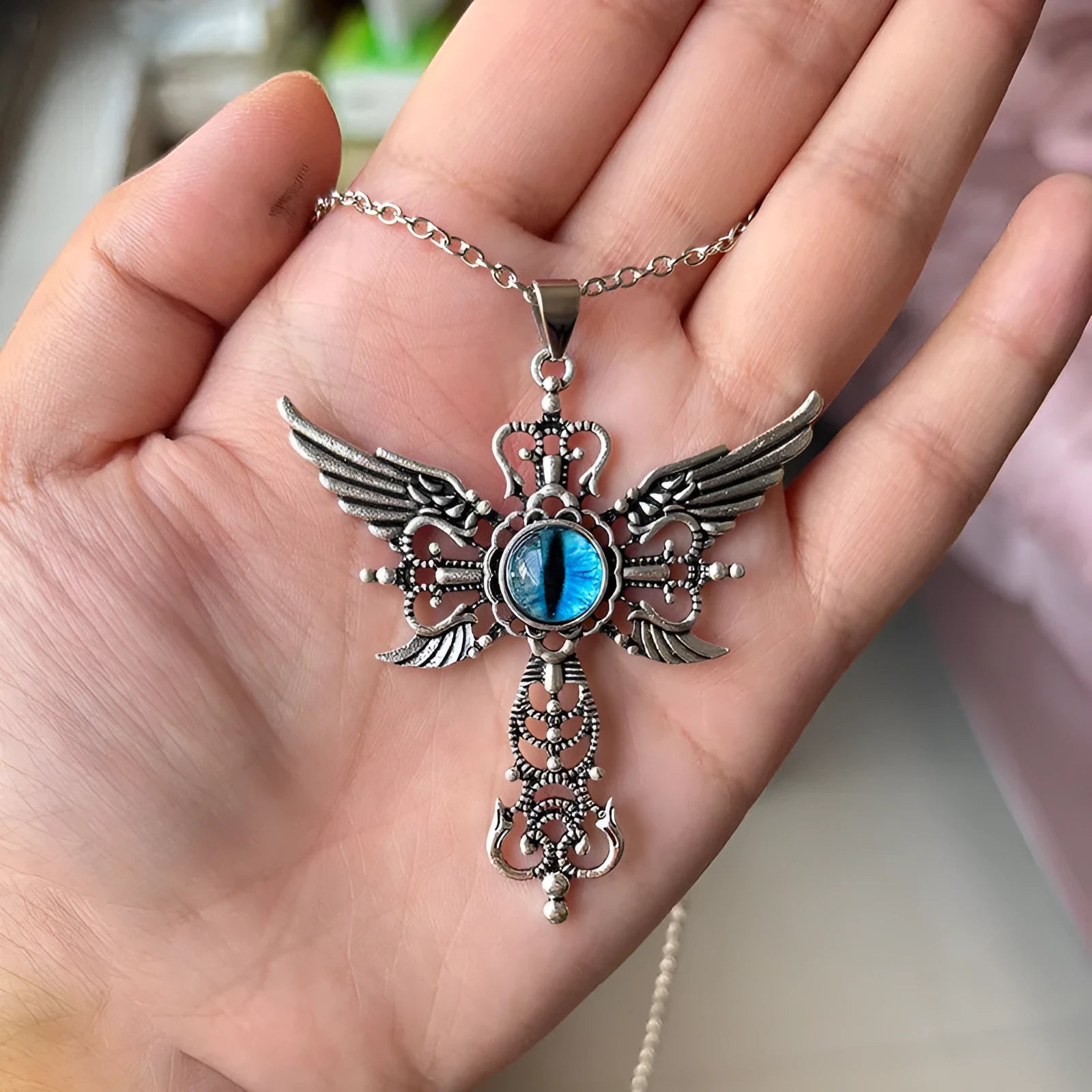 Geometric devil wings cross pendant necklace in alloy metal showing colour options