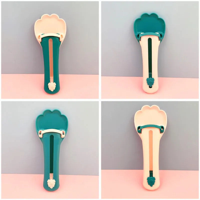 Pink and green pet feed spoon with squeezer mechanism for wet food and treat dispensing
