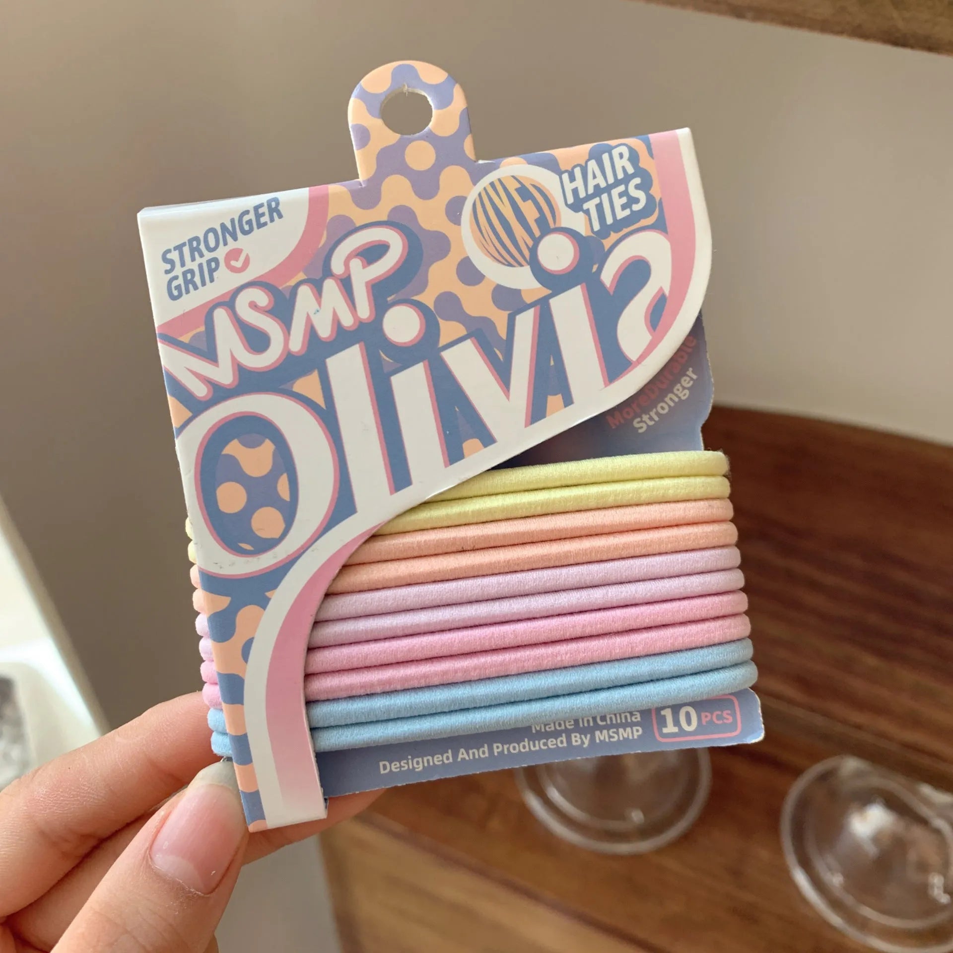 Assortment of candy colour braided elastic hair bands laid flat, showing textured rubber design.