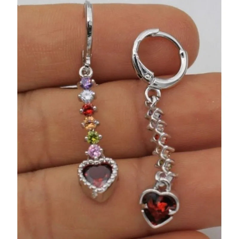 A pair of women's heart-shaped fashion earrings in a gold or silver alloy metal finish.