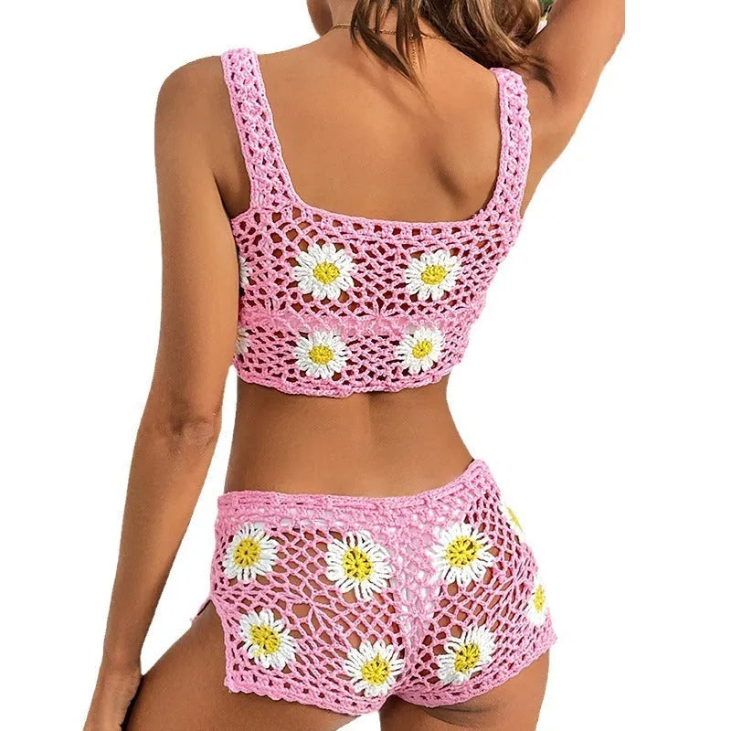 Light green floral patterned bikini swimsuit with top and pants on a plain background.