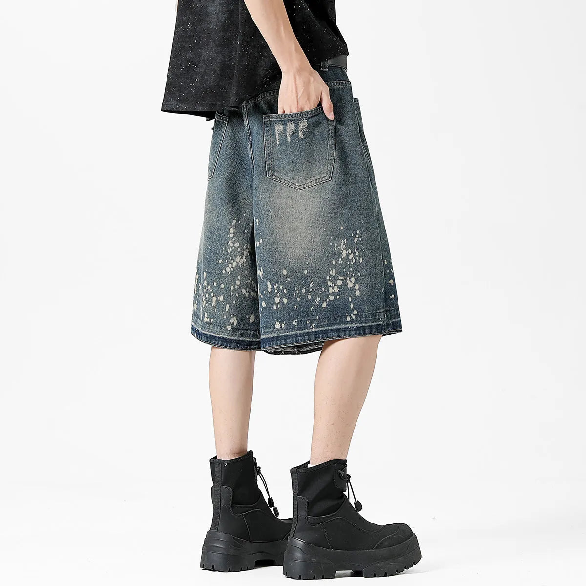 Men's retro blue denim shorts with distressed splash ink design and straight leg cut.
