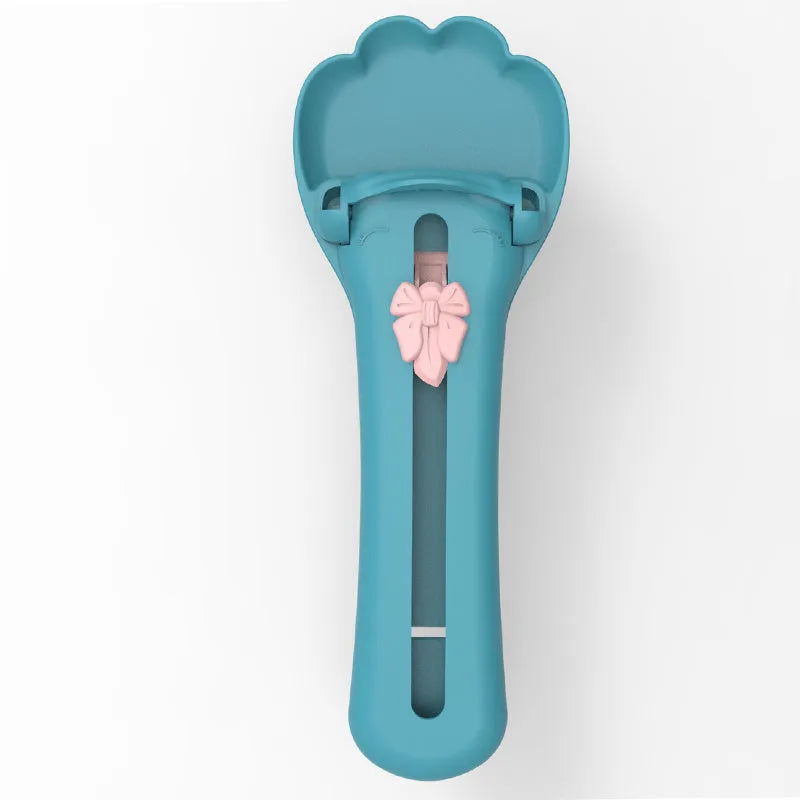 Pink and green pet feed spoon with squeezer mechanism for wet food and treat dispensing
