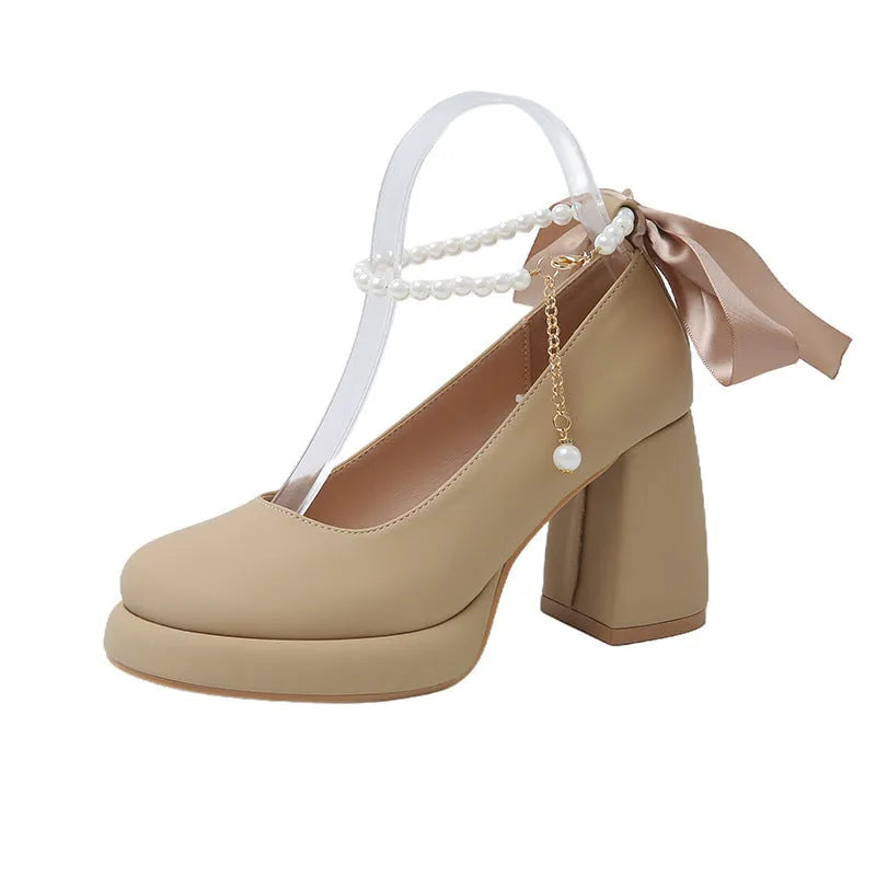 Women's beige Mary Jane shoes with a chunky heel, round toe, and a buckle fastening on the ankle strap.