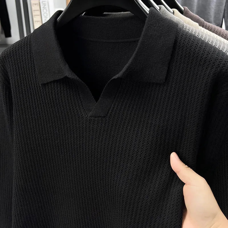 Man wearing a loose-fit camel-coloured pullover sweater, a simple casual knit for autumn.