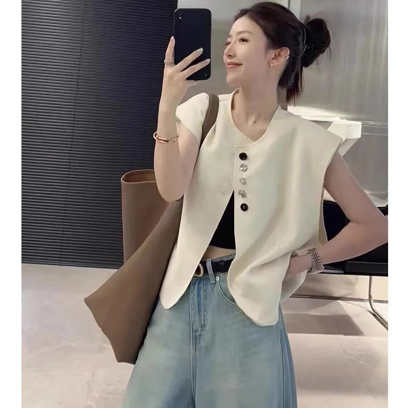 Women's loose fit polyester vest in milky white, featuring a short length and a front pocket.