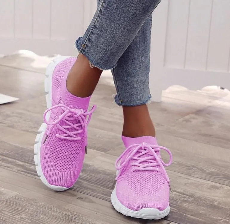 Women's casual breathable flying knit flat shoes in various colours on a white background.