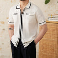 Slim-fit man's knitted polo shirt with a lapel collar and short sleeves in a black viscose blend fabric.
