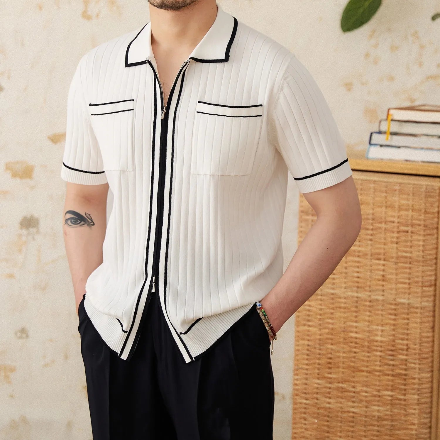 Slim-fit man's knitted polo shirt with a lapel collar and short sleeves in a black viscose blend fabric.