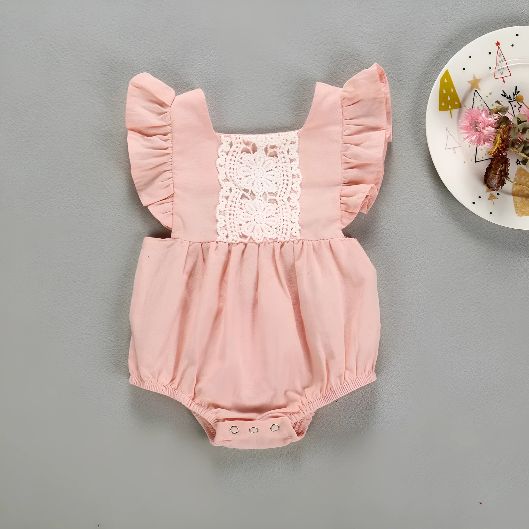 Camellia ruffles romper for baby girls with floral patchwork and back cross design in pink colour