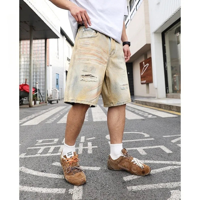 Light blue men's denim shorts with ripped details and a straight-leg cut on a mid-rise waist.