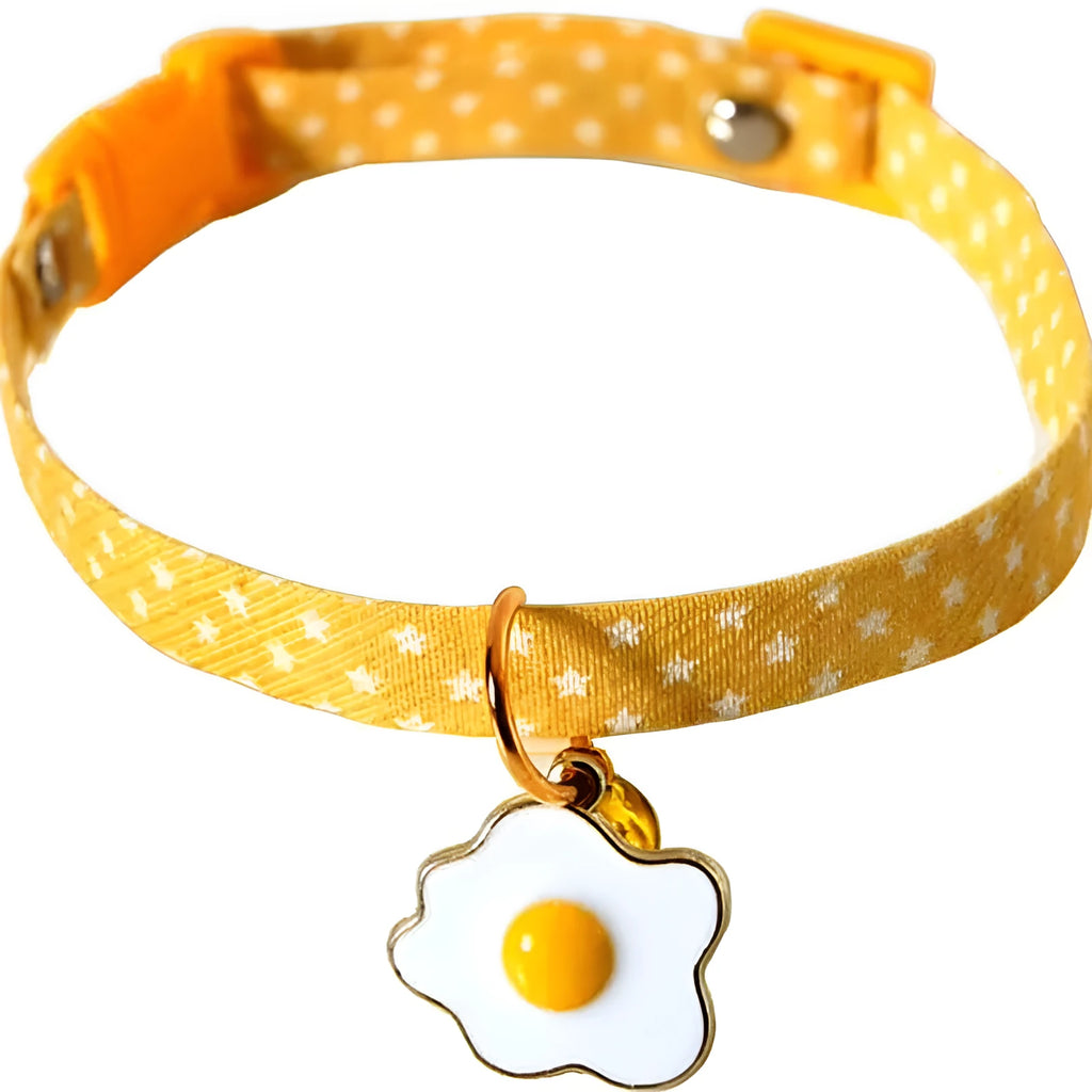 Green adjustable pet collar with a metal bell pendant and a matching bow tie on a white background.