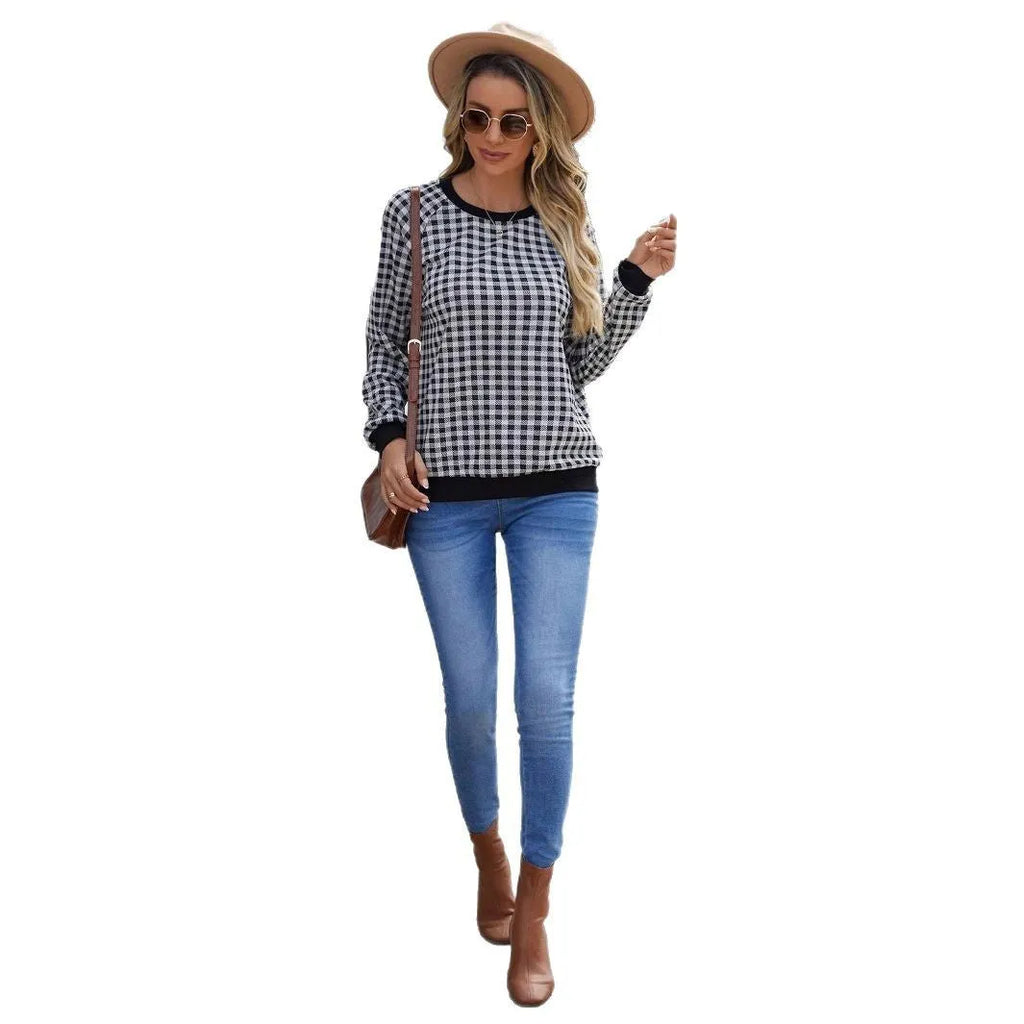 Black long sleeve pullover sweater with plaid pattern and printing detail showing front view