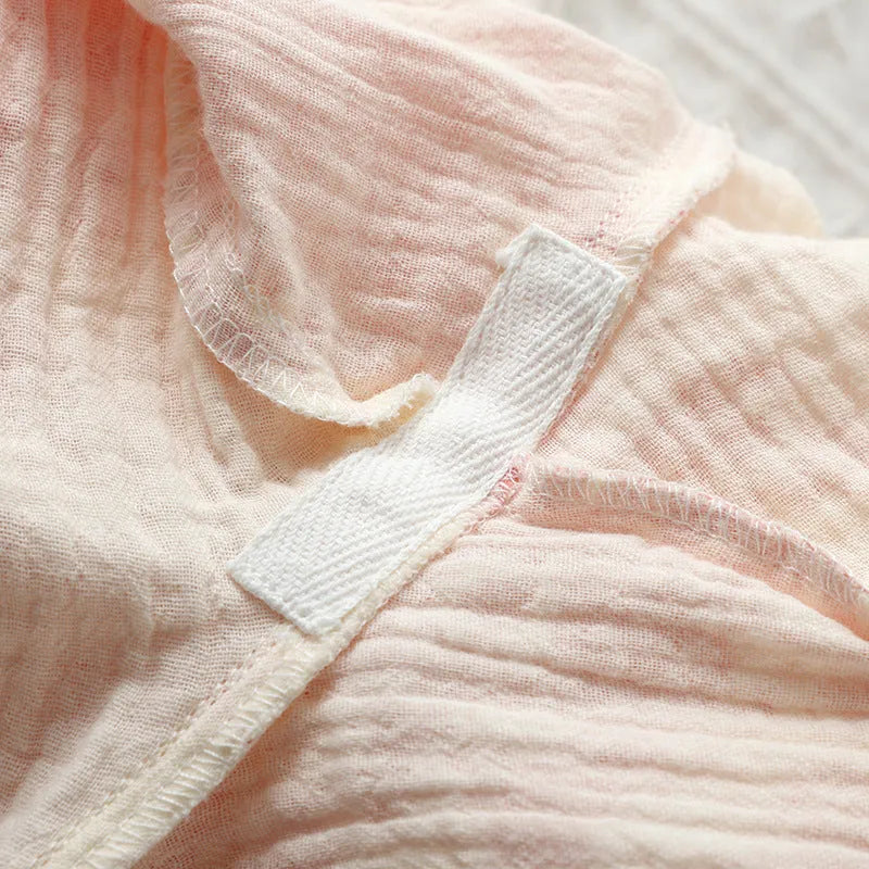 Women's pink pure cotton gauze lounge set with lace-up trousers and long sleeve top.
