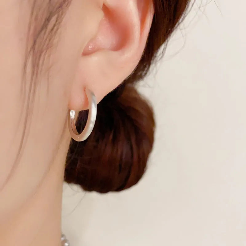 Geometric women's ear clip jewellery with simple eyelet design in gold or silver colour