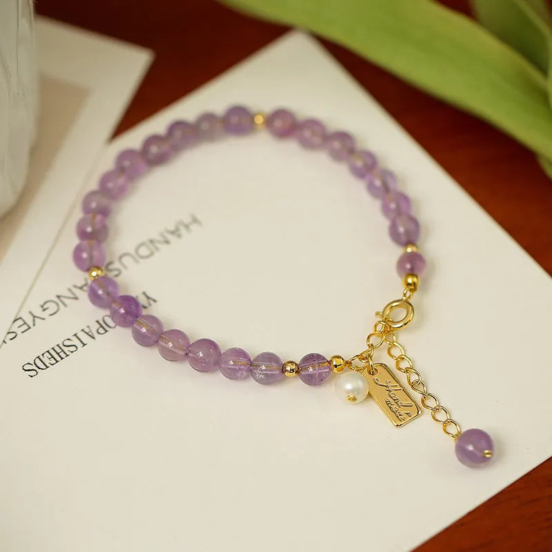 Women's natural lavender amethyst crystal bracelet showing dark and light colour options