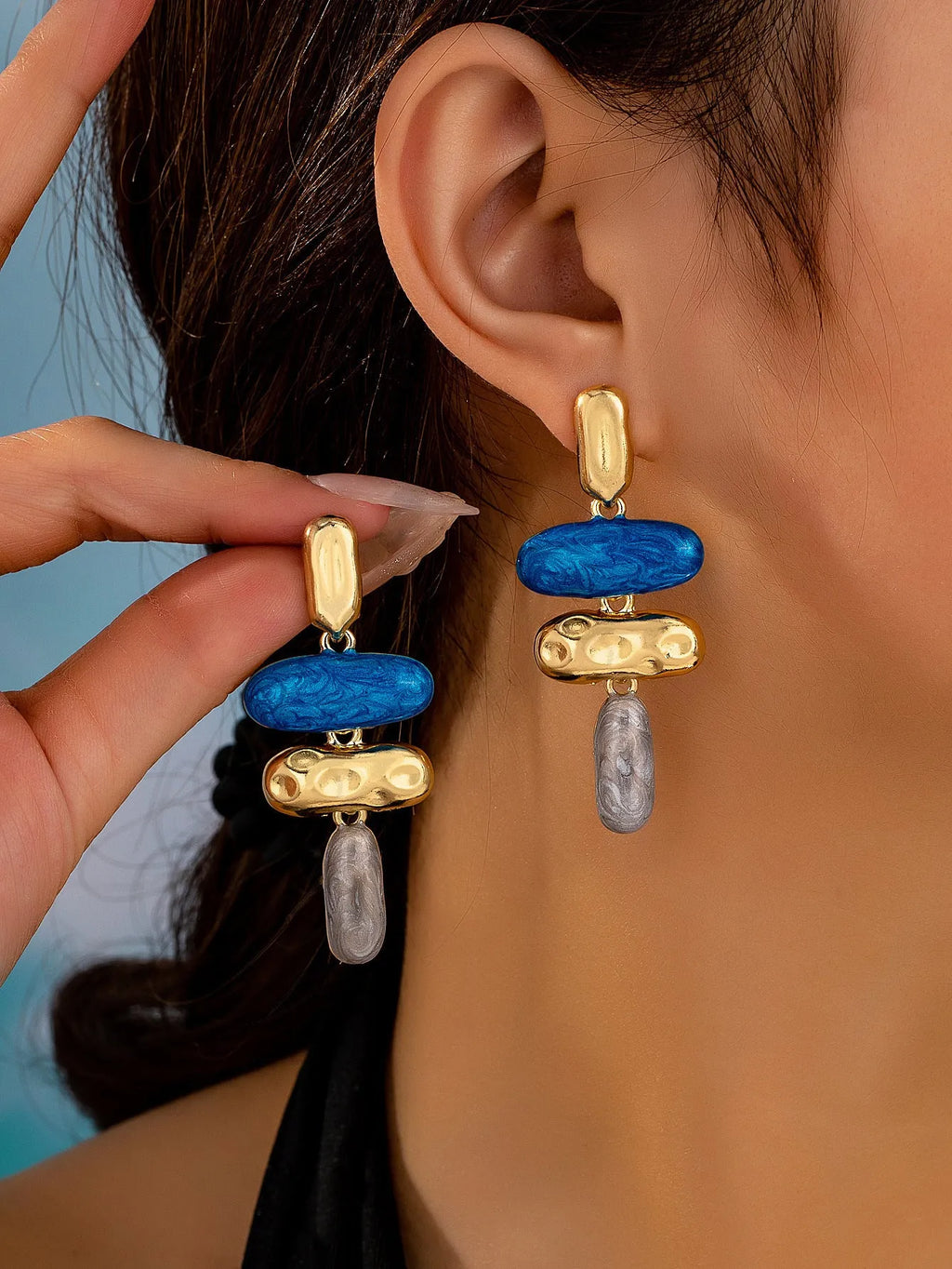 A pair of simple geometric stud earrings with a multicolour electroplated finish.