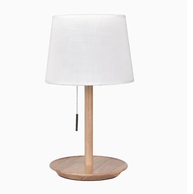 Walnut-coloured solid wood bedside lamp with fabric shade and cable switch