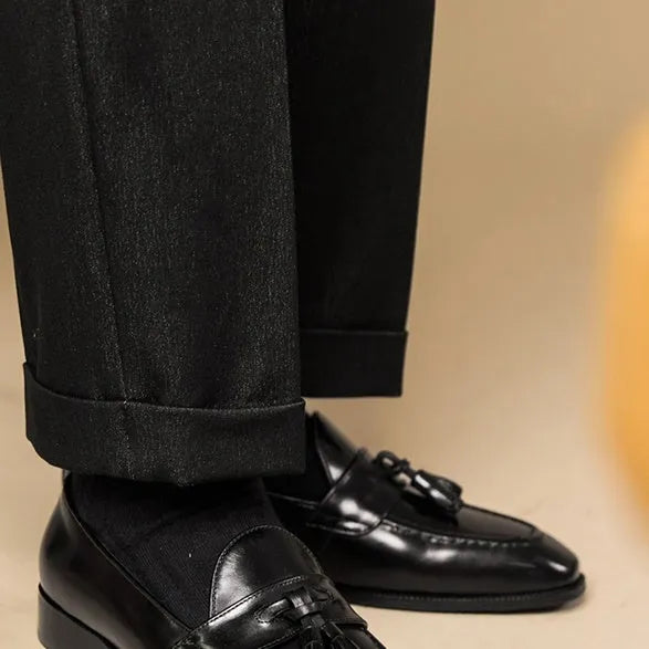 Men's black and brown polished leather tassel loafers with pigskin lining and rubber soles