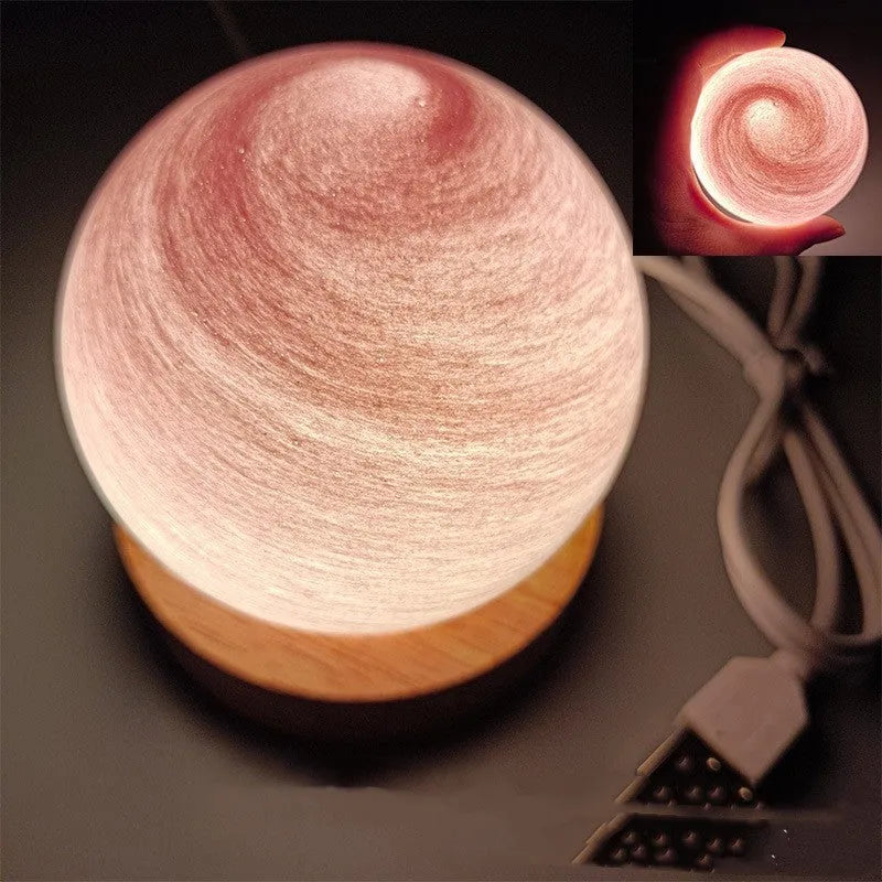 Planet night light with USB cable and base in modern simple design showing spherical shape