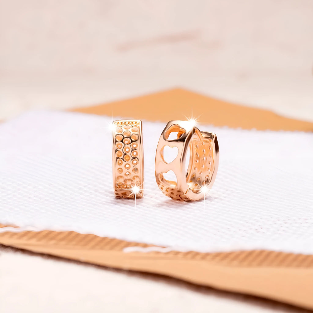 Rose gold women's earrings with hollowed out heart design in circular frame