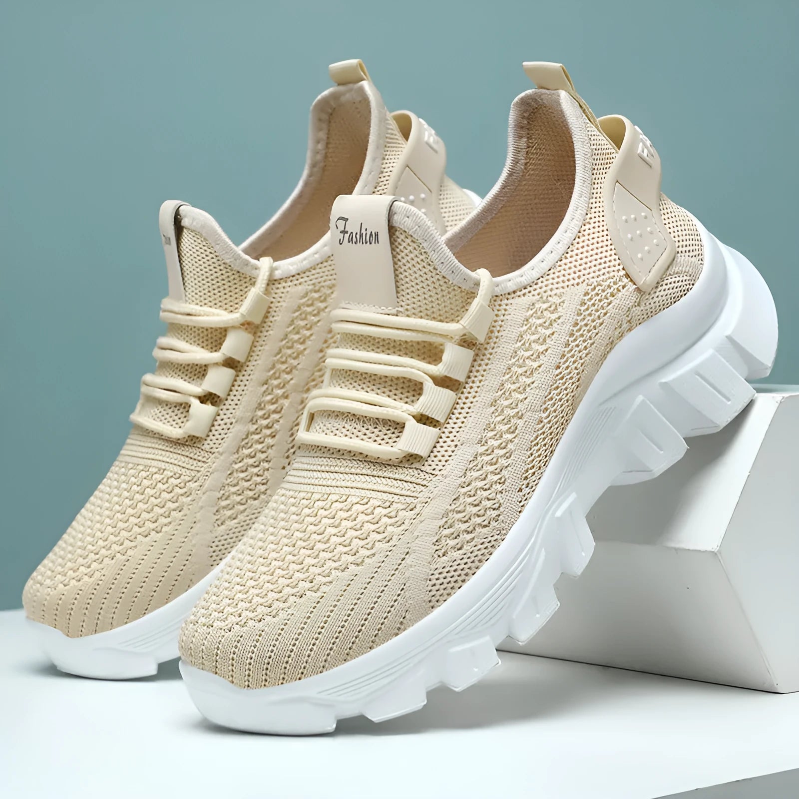 Women's white Flyknit running sneakers with round toe, flat heel, and thick PVC sole on a light background.