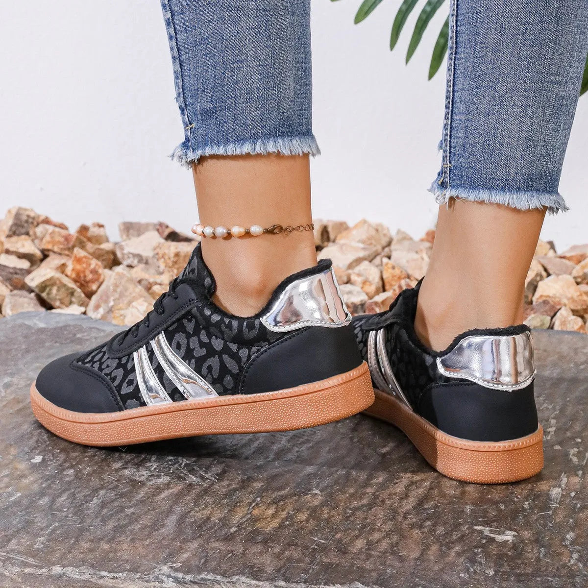 Women's casual running shoes with black microfiber upper, round toe, low top, and rubber sole against white background
