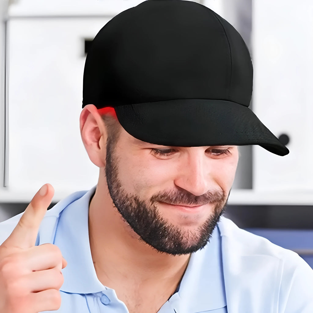 Black infrared peaked cap with 180 red LED lights for hair growth therapy on a stand.