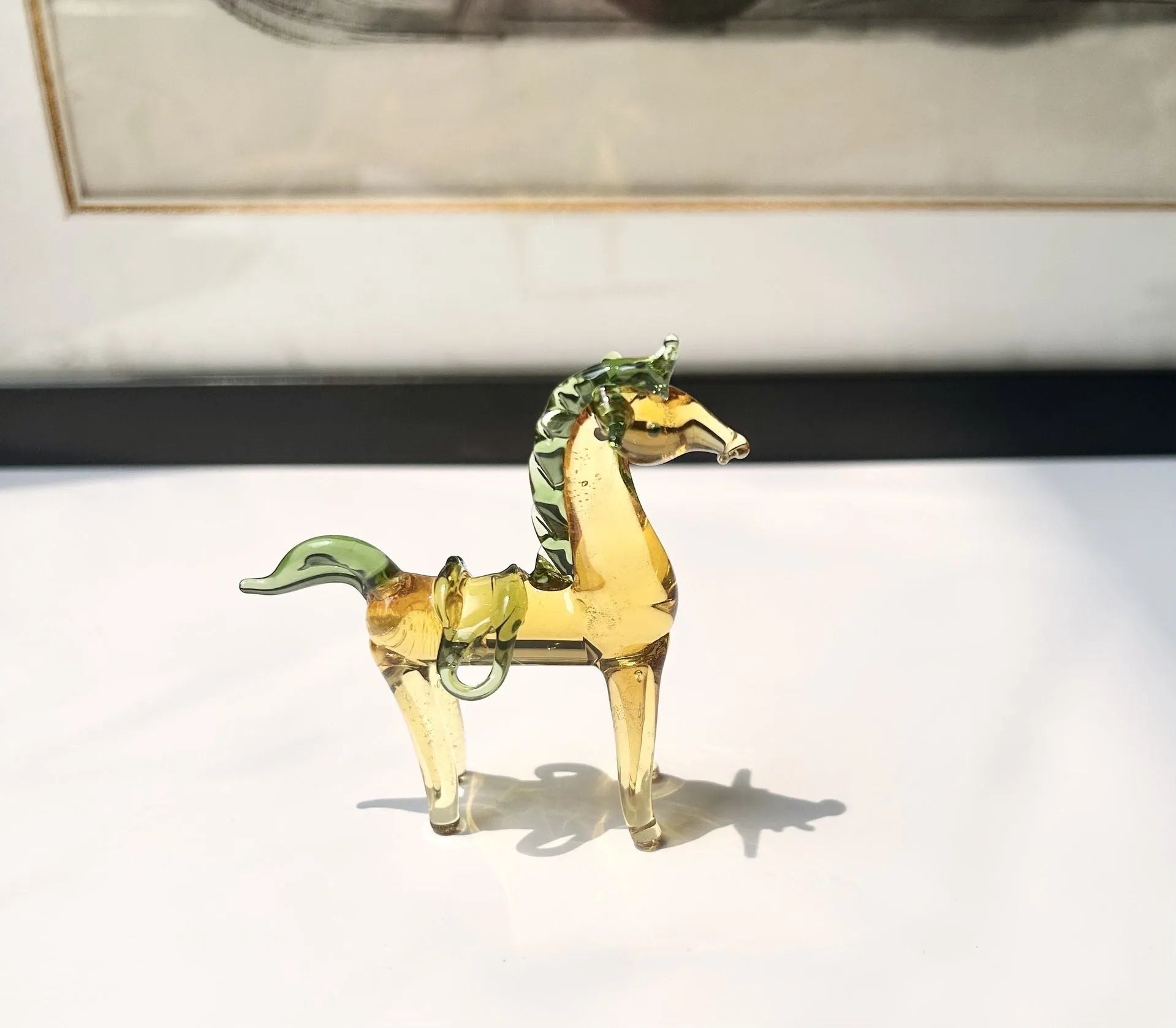 Brown glazed ceramic horse ornament on wooden shelf