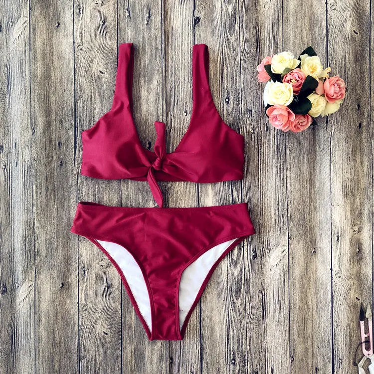 Women's solid colour bikini set showing bra top and matching panties in polyester fabric