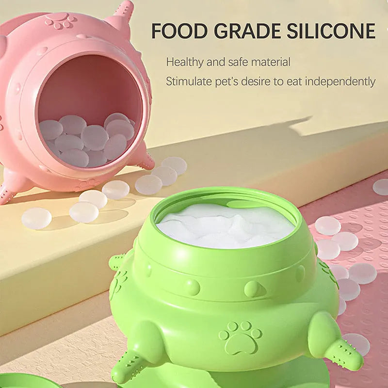 Pink silicone pet nursing feeder with bionic breast-shaped bowl and four pacifiers on a white background.