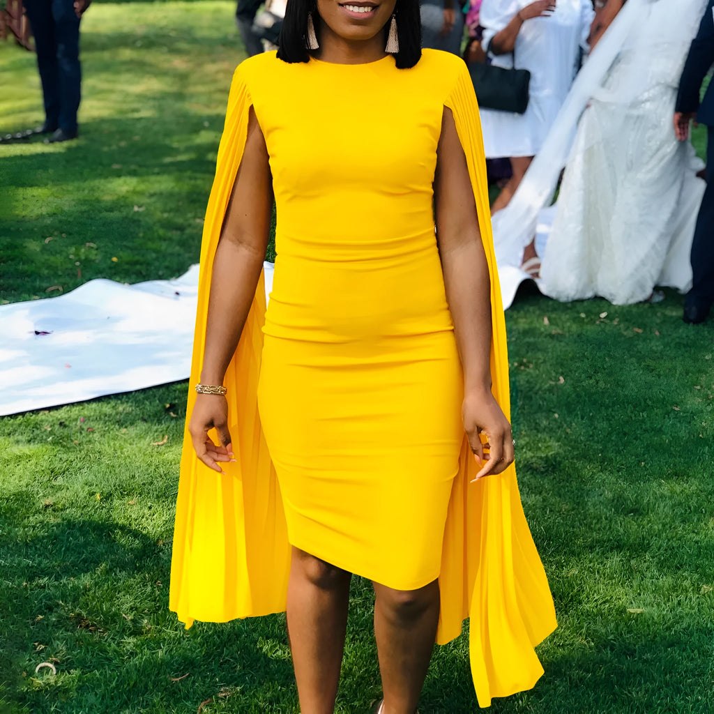 Yellow round neck evening gown with pleated shawl, long sleeves, and a high waist.