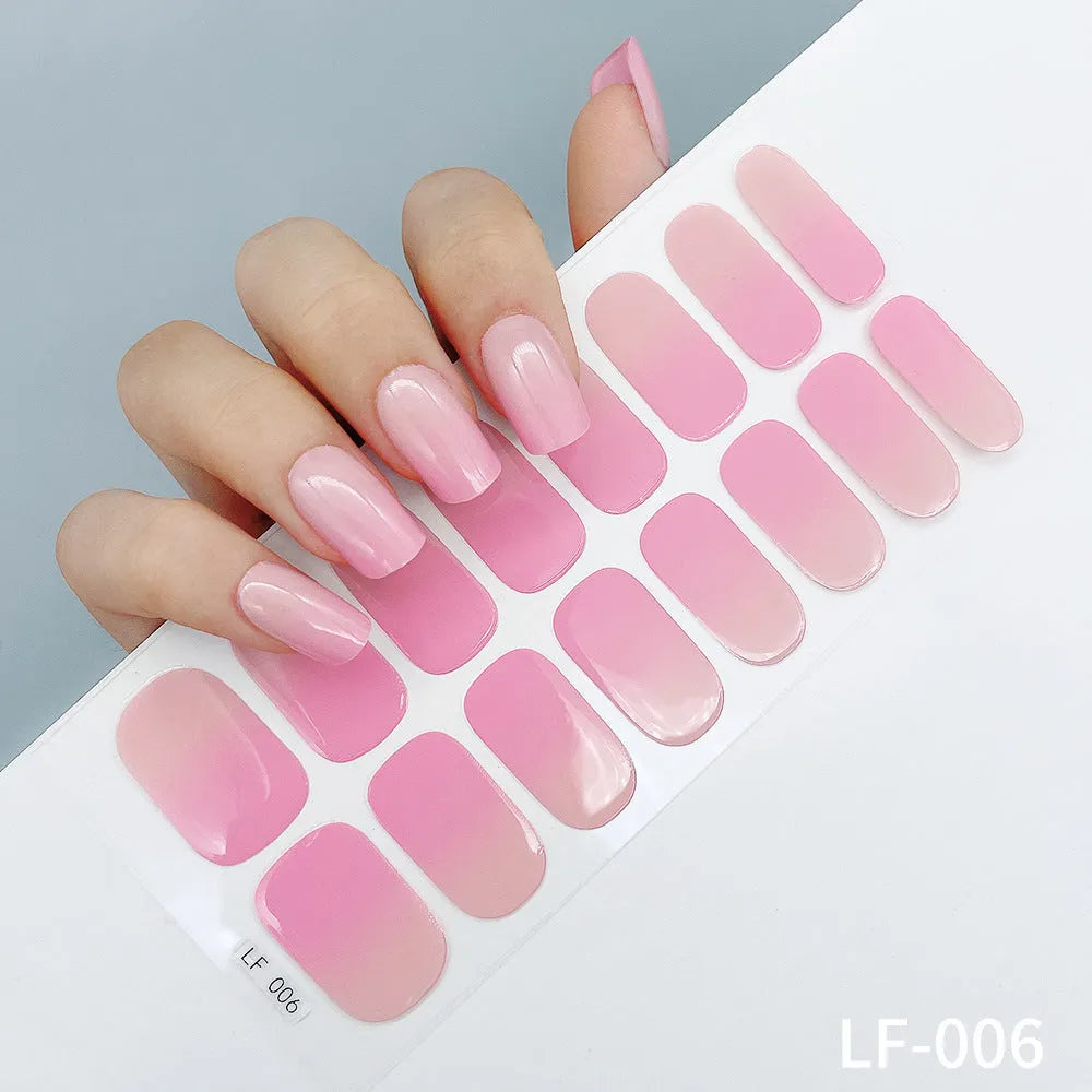 Set of 16 solid colour full nail art stickers showing patterns like cross, rose, tulip, and cartoon designs.