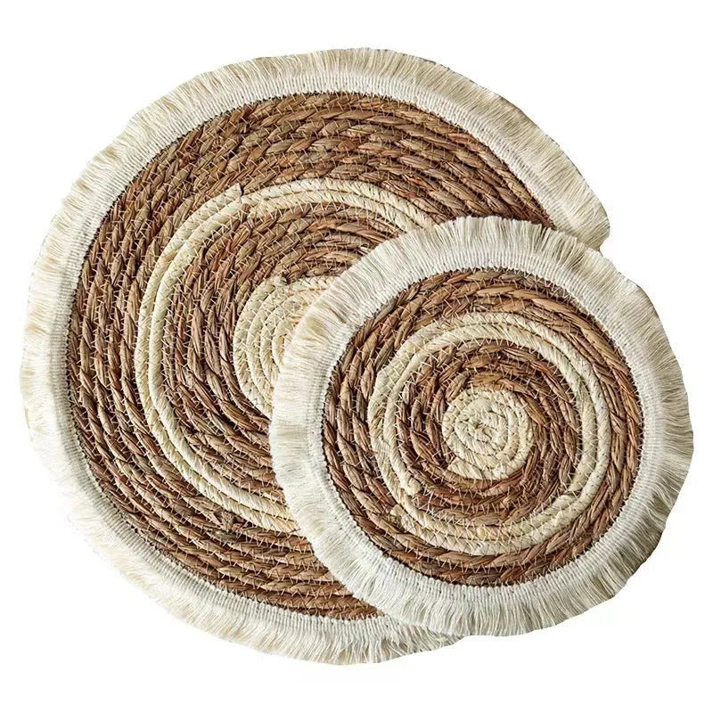Japanese straw round placemat with tassel trim in natural papyrus material on dining table