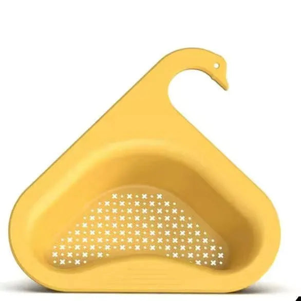 Yellow hanging swan drain basket made of plastic, fitted on a kitchen sink edge with space for vegetables and utensils